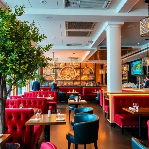 Interior view of Docks Off 5th seafood restaurant showcasing plush seating and greenery