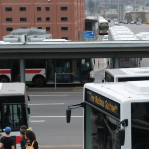 A busy bus station in Memphis with people and buses.