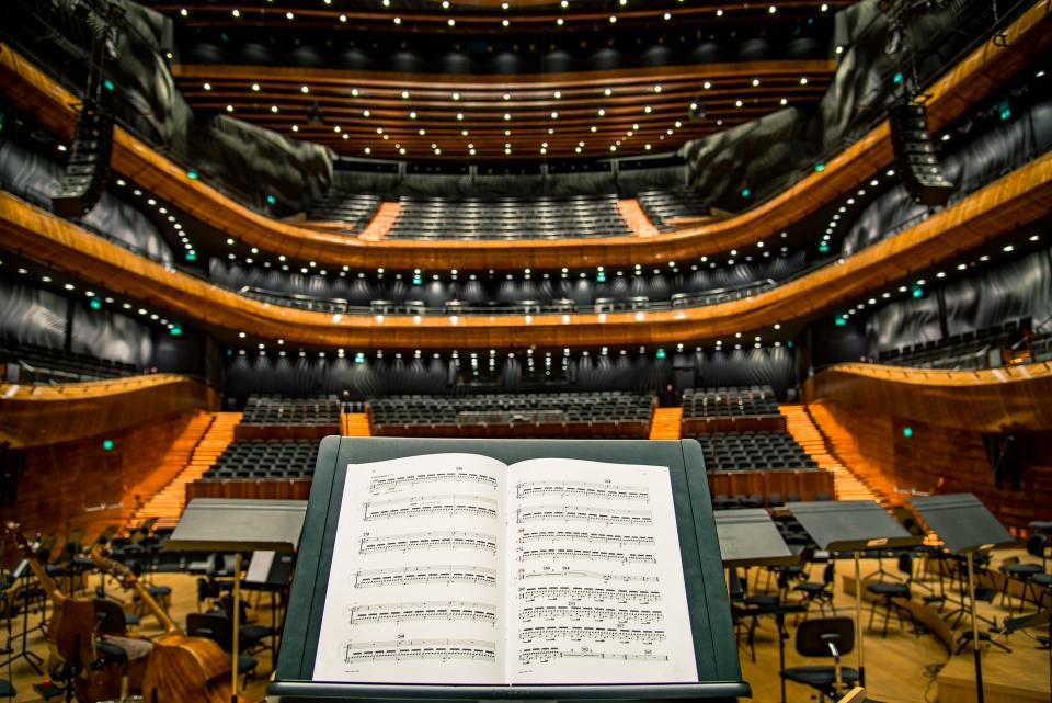 Concert hall stage lights over empty seats